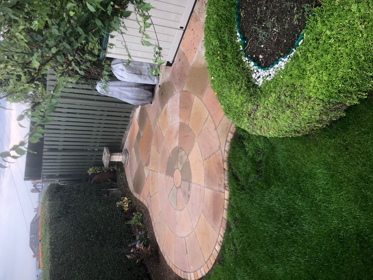 Indian sandstone circle patio with box topiary and bird bath by Design My Garden Edinburgh