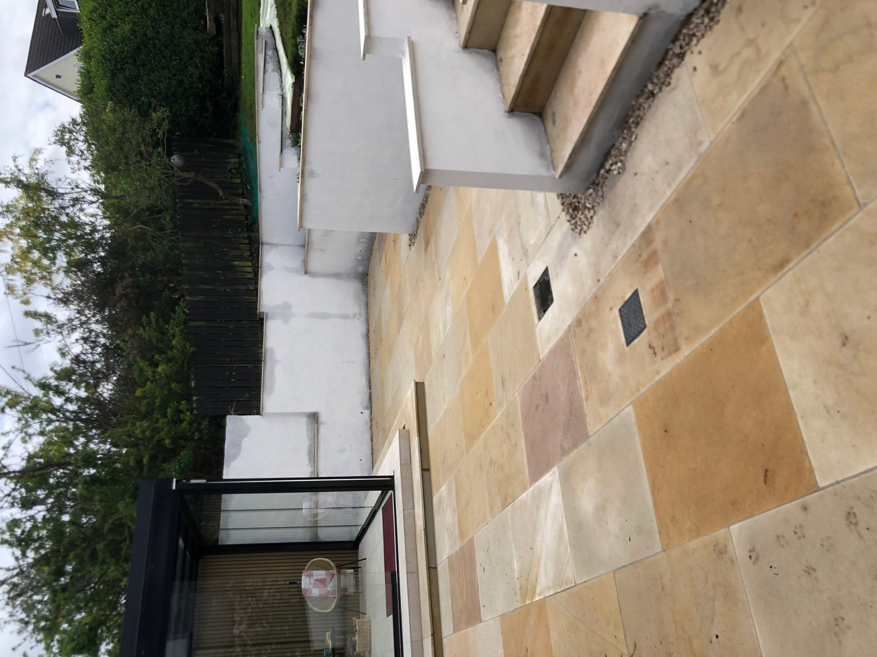 Indian sandstone patio with garden room and sliding glass doors - Edinburgh garden design