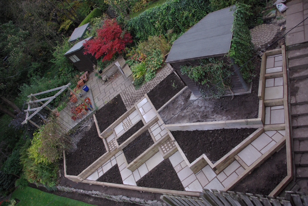 Sloped terraced garden with raised beds, sandstone steps and summerhouse - Edinburgh